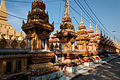 Vientiane, Laos - Pha That Luang, Other structures on the ground include a bell tower, several stupas, a number of pavilions sheltering images of the Buddha.  